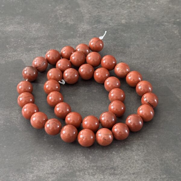 Perles 10 mm jaspe rouge ancrage et protection