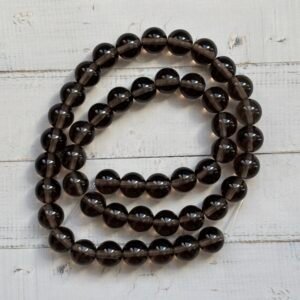 Perles Larmes d’Apache noires et translucides, symbole de protection et de libération émotionnelle.